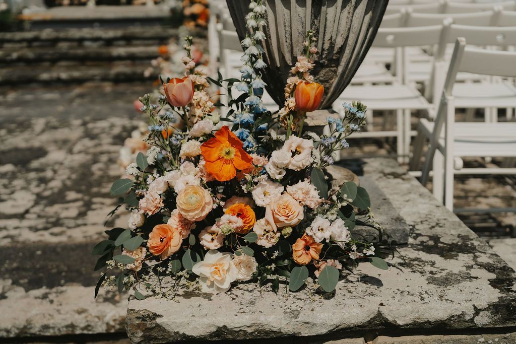 a bride and groom are walking down the aisle at their wedding .