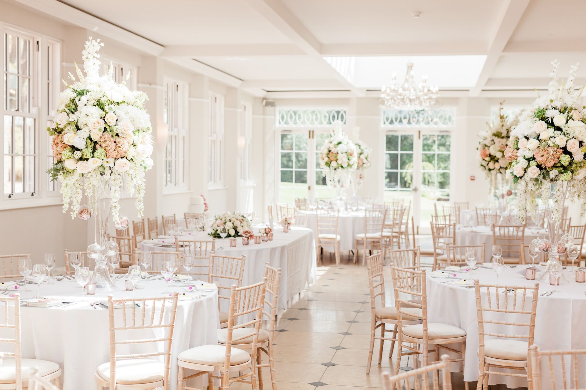 a large room with tables and chairs set up for a wedding reception.