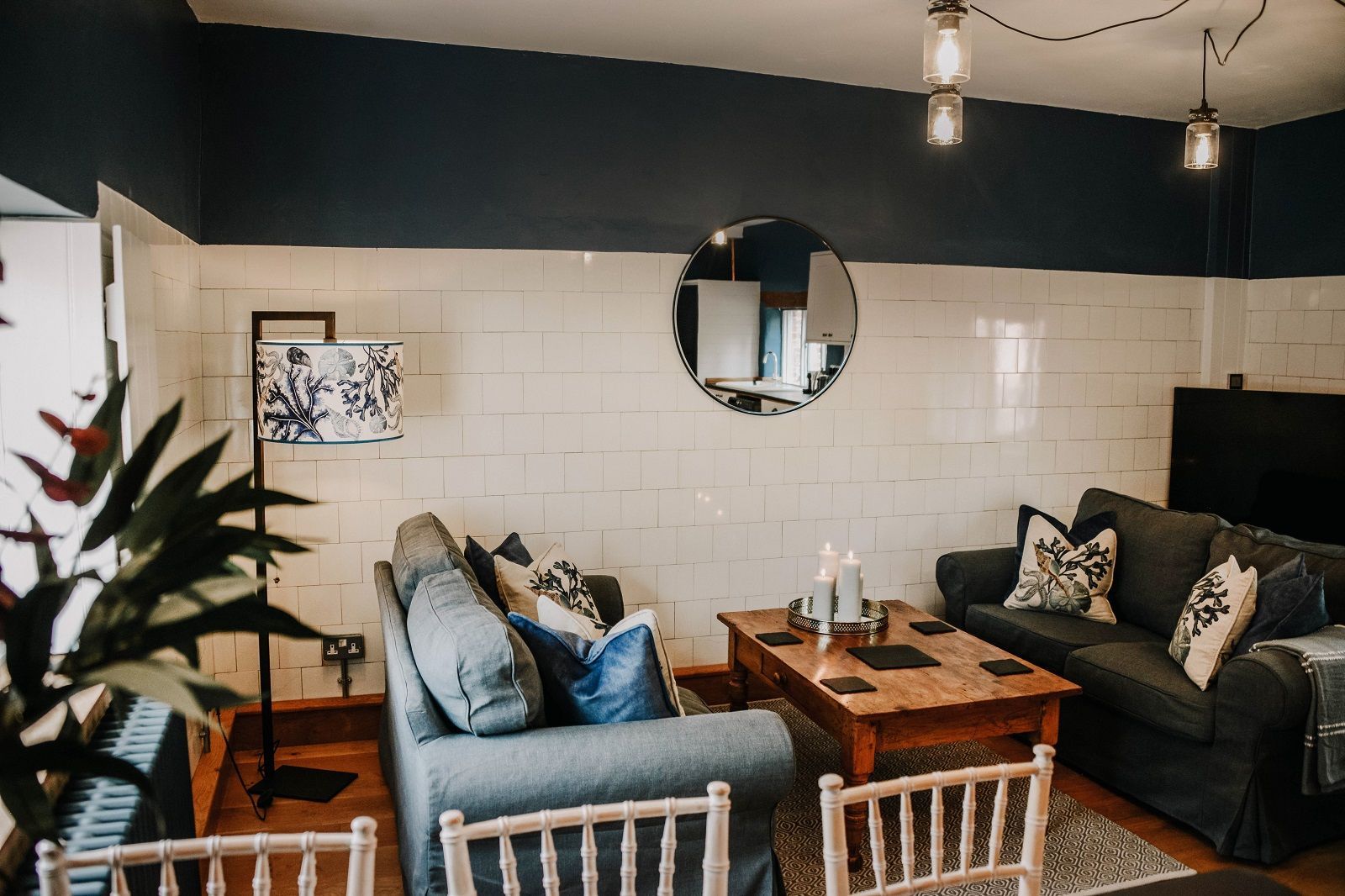 a living room with a couch , table , chairs and a piano. Wedding accommodation
