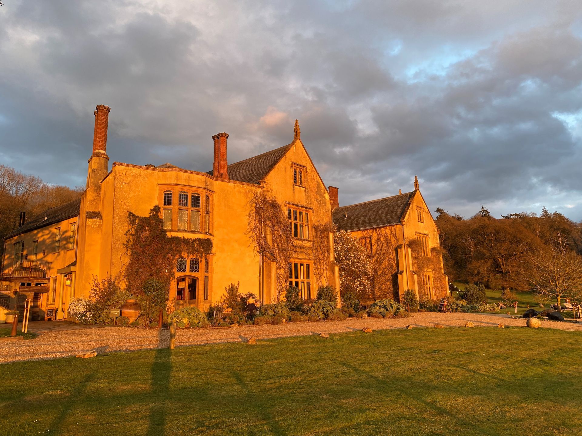 a large yellow house with a cloudy sky in the background