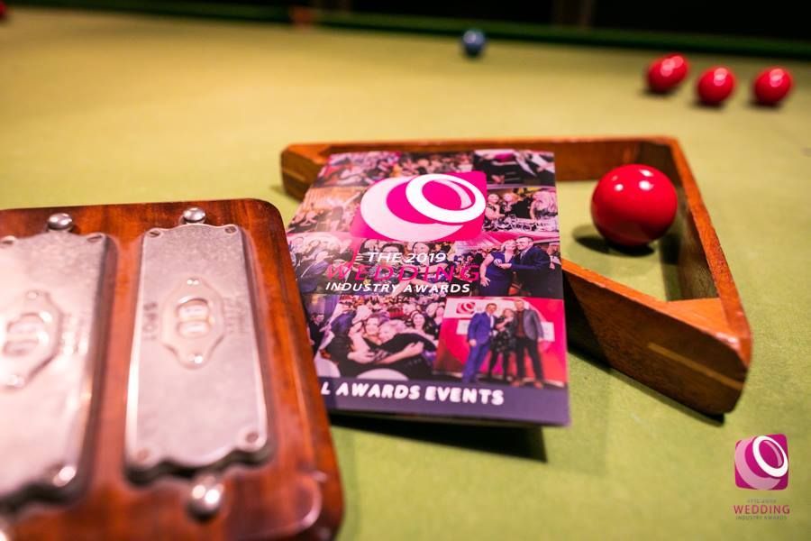 a pool table with balls and a card on it