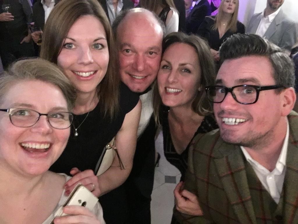 a group of people are posing for a picture at a party .