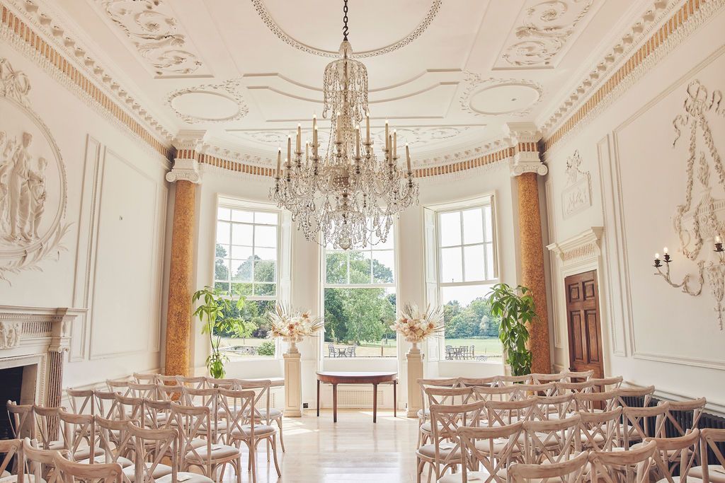 a large room with rows of chairs and a chandelier .