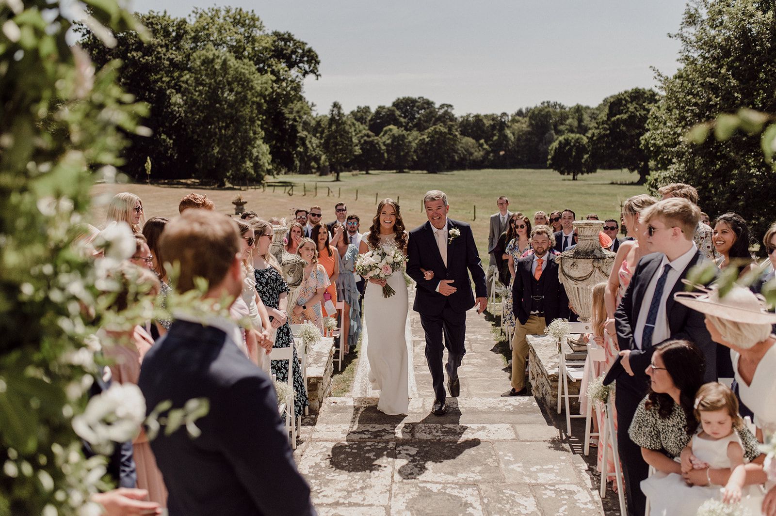 a bride and groom are walking down the aisle at their wedding .