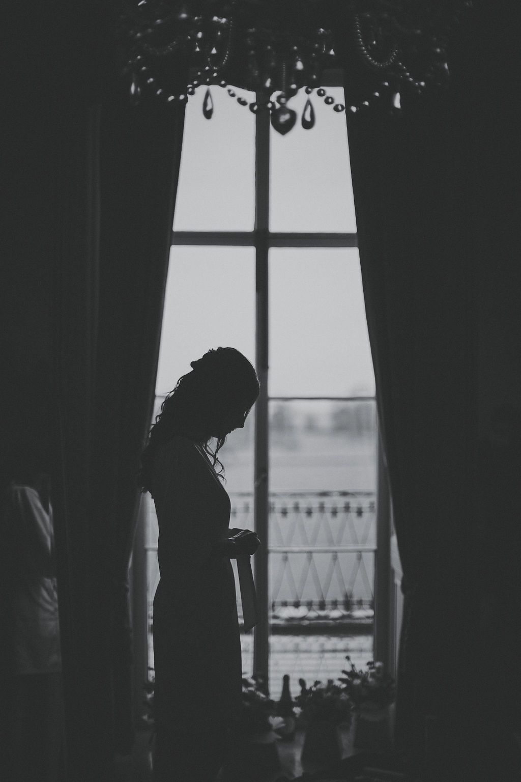 Bride sitting by the window 