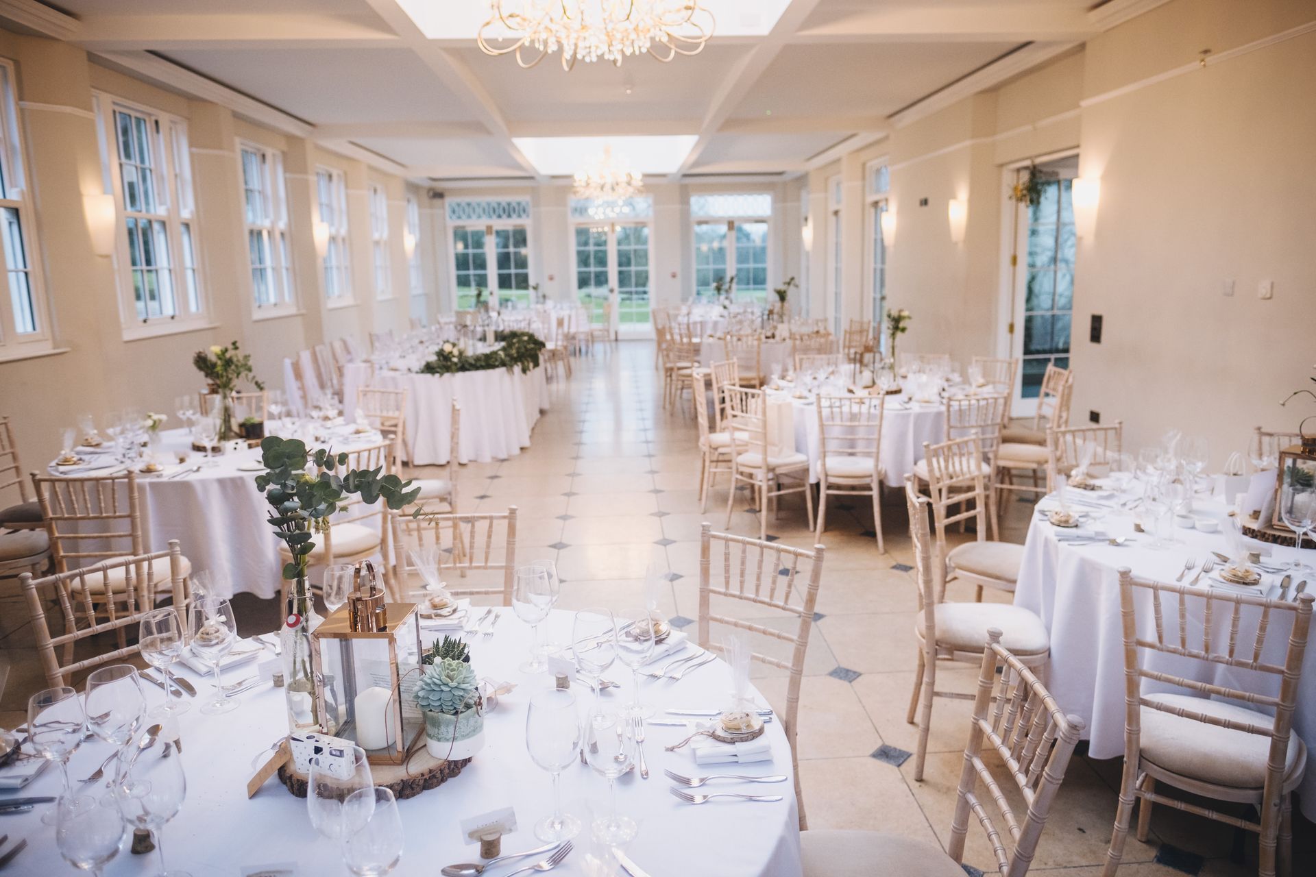 a large room with tables and chairs set up for a wedding reception .