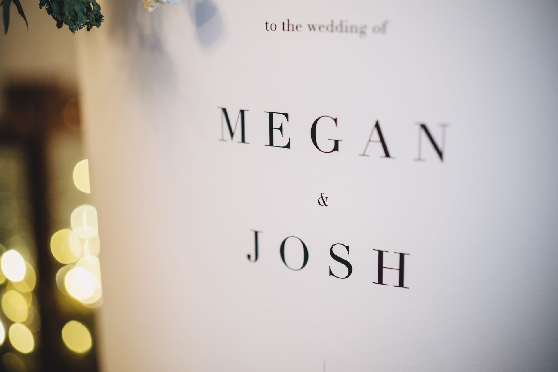 a close up of a wedding invitation for Megan and Josh