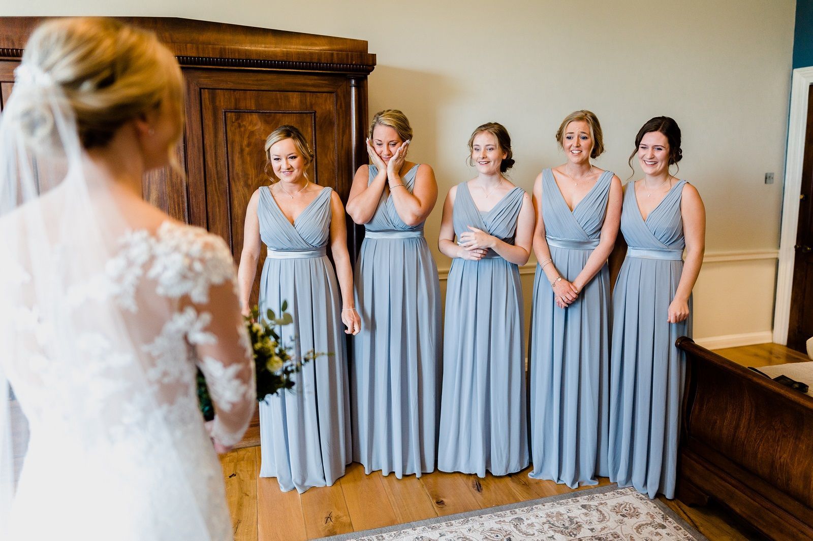 a bride and her bridesmaids are standing next to each other in a room .