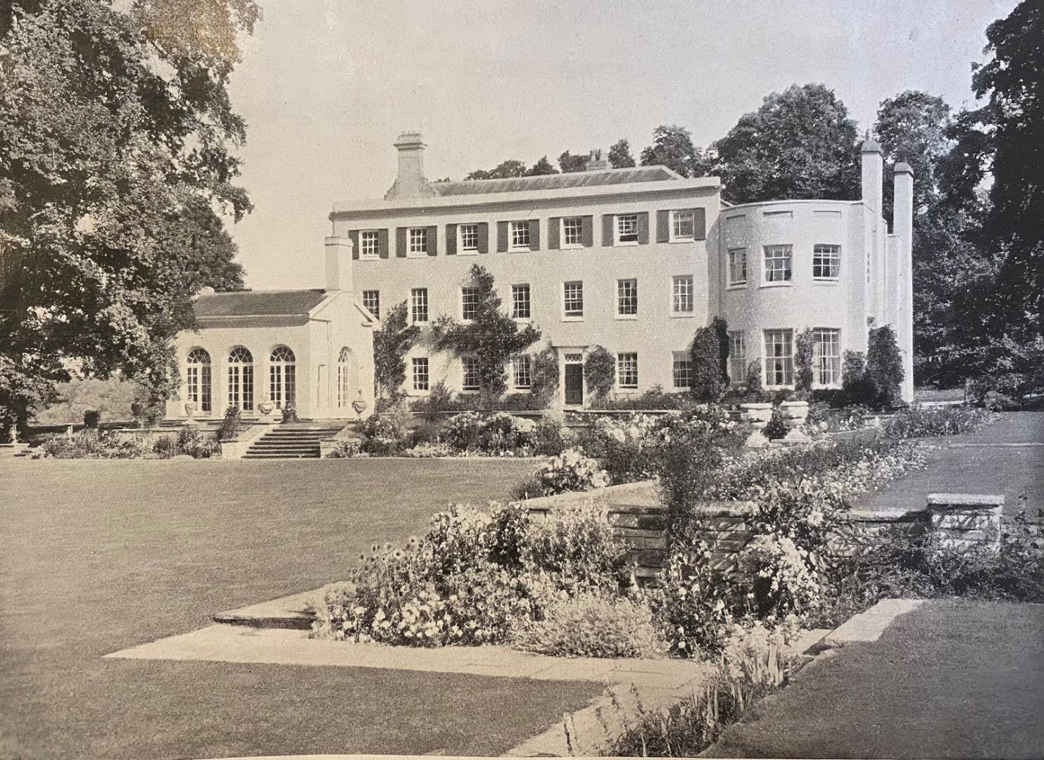 a black and white photo of a large white house
