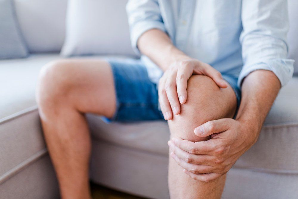 Man Holding His Legs — Mountain Creek Physiotherapy Clinic in Mountain Creek, QLD