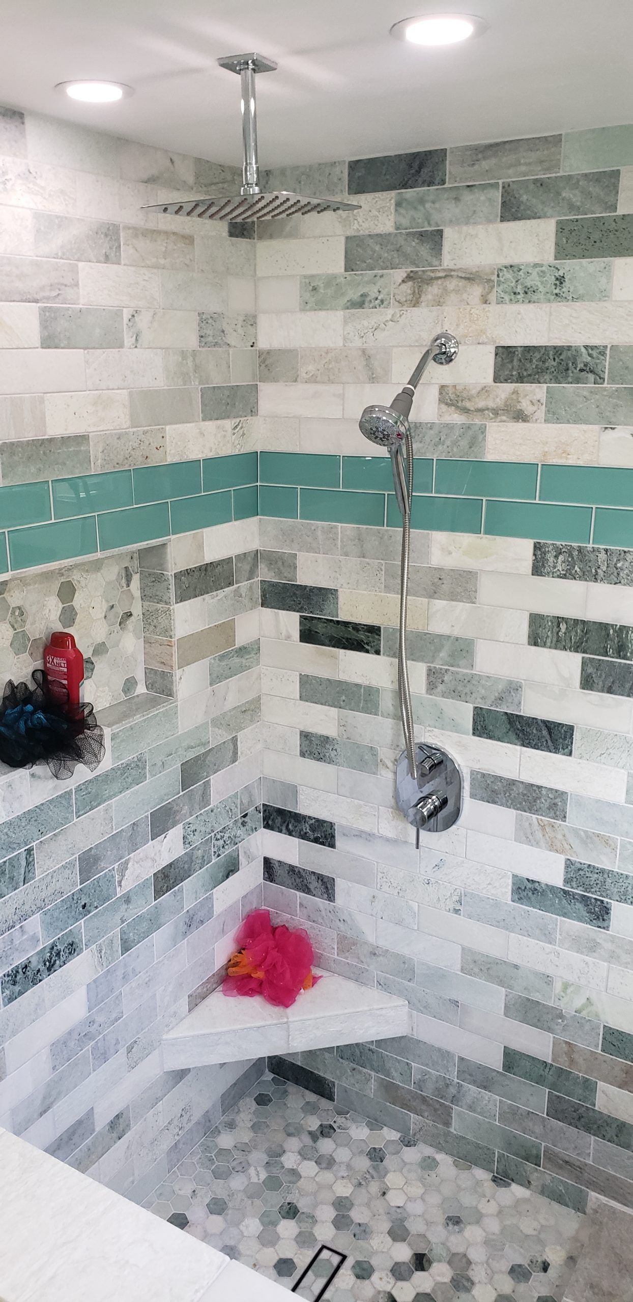 A bathroom with a sliding glass shower door from a Bathroom remodel in San Diego CA by Team Renovate