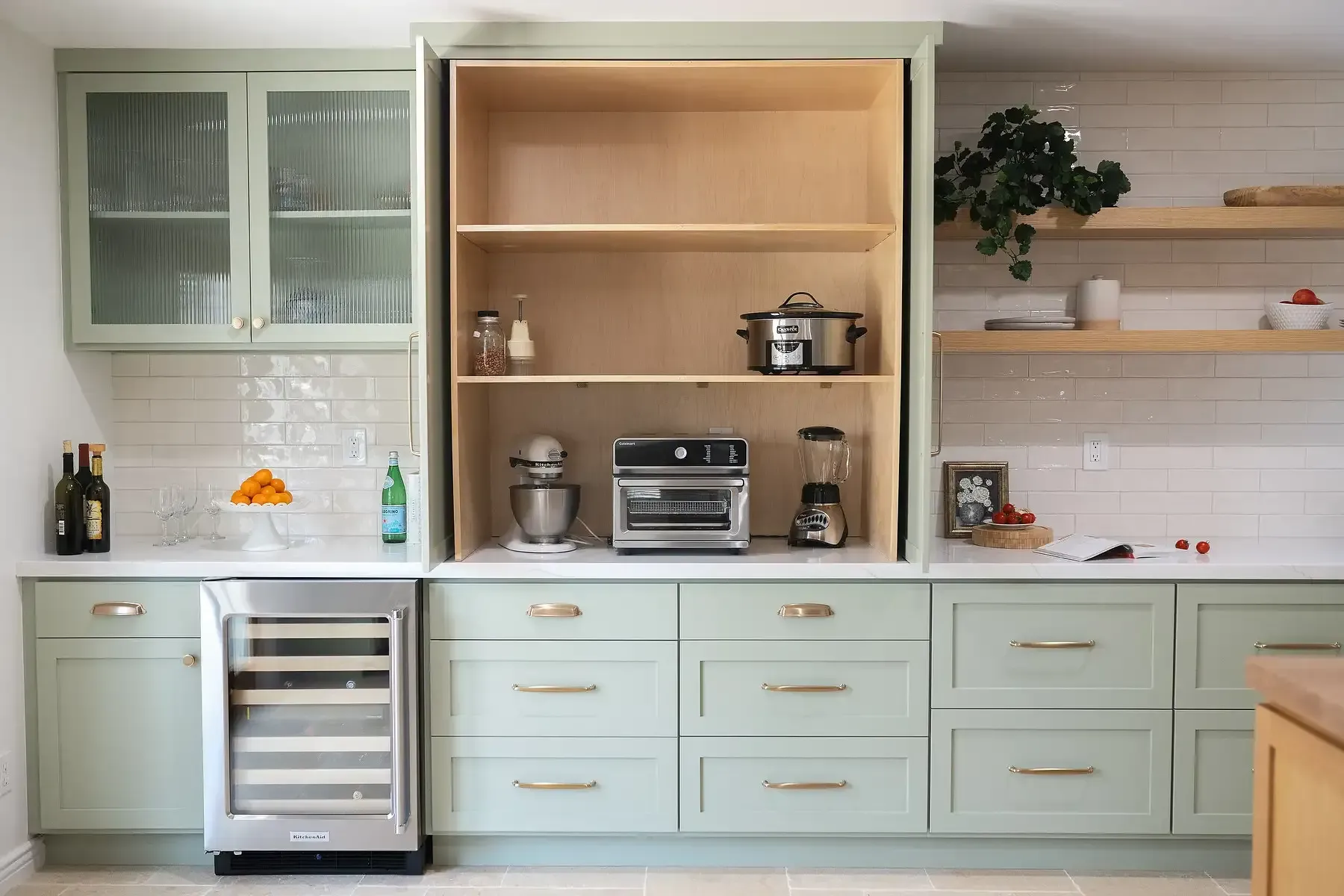 Team Renovate - Sage green kitchen cabinetry with built-in appliance area