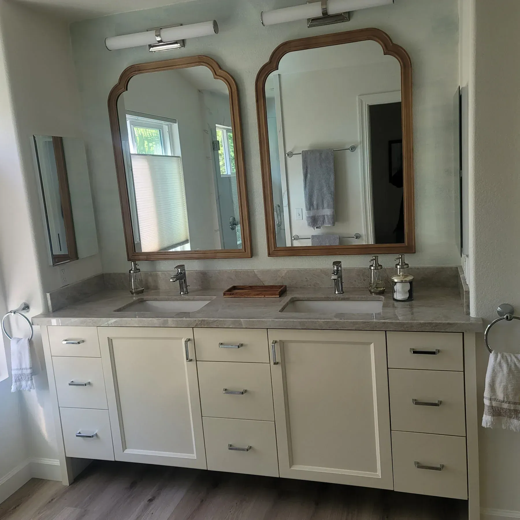 A bathroom with two sinks and two mirrors from a Bathroom remodel in San Diego CA by Team Renovate