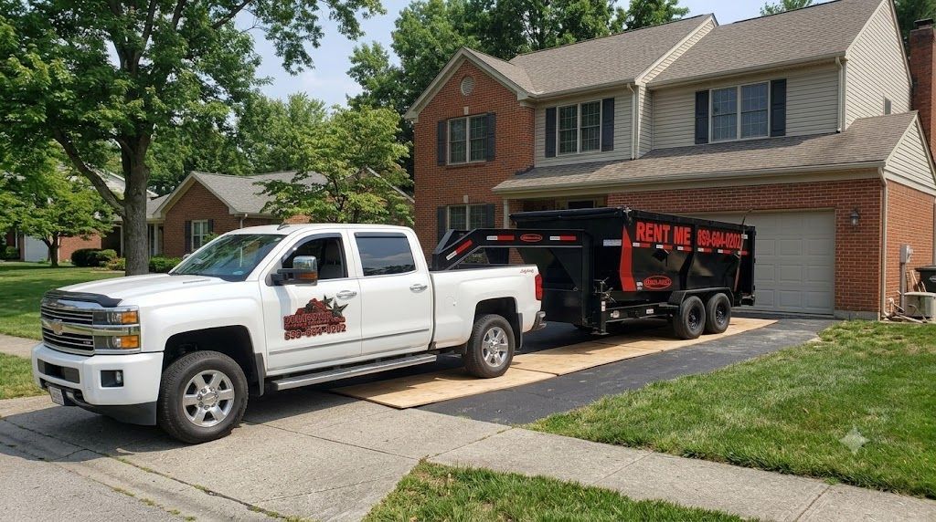 Roll-off truck backing a dumpster into a Lexington, KY driveway showing delivery clearance space