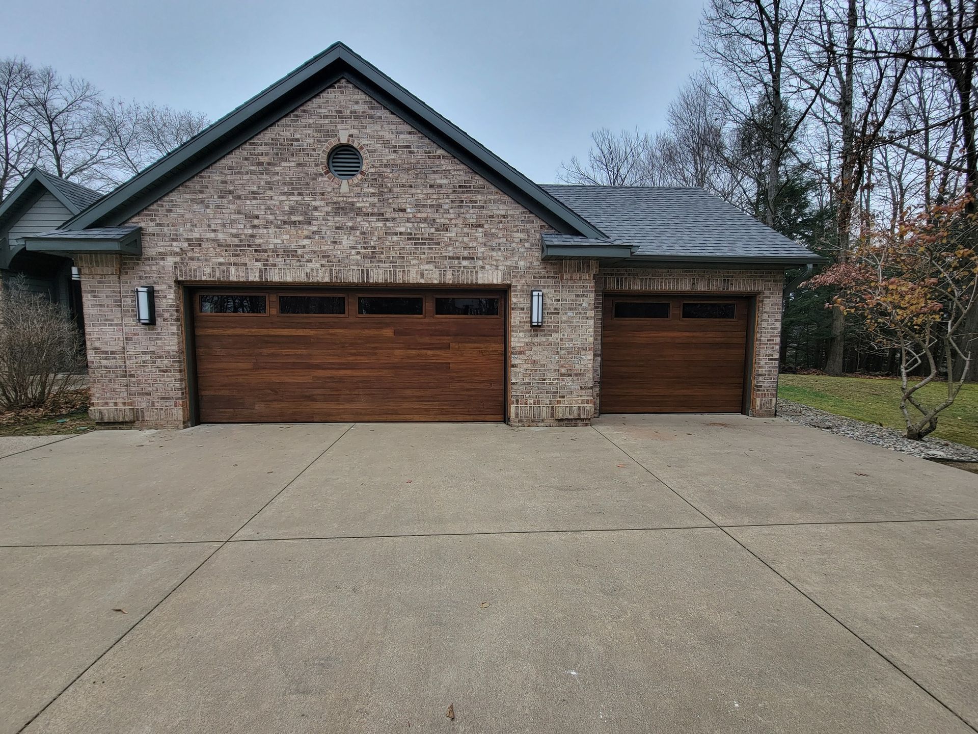 Two-story brick house with a double garage and wide concrete driveway
