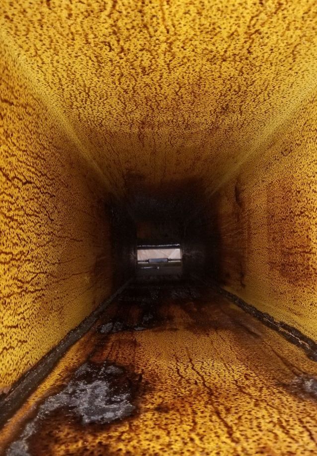 a close up of a yellow wall with a hole in the middle .