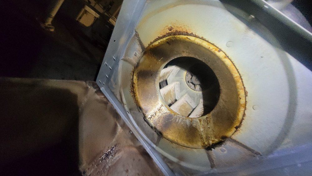 a close up of a rusty fan with a hole in the middle .