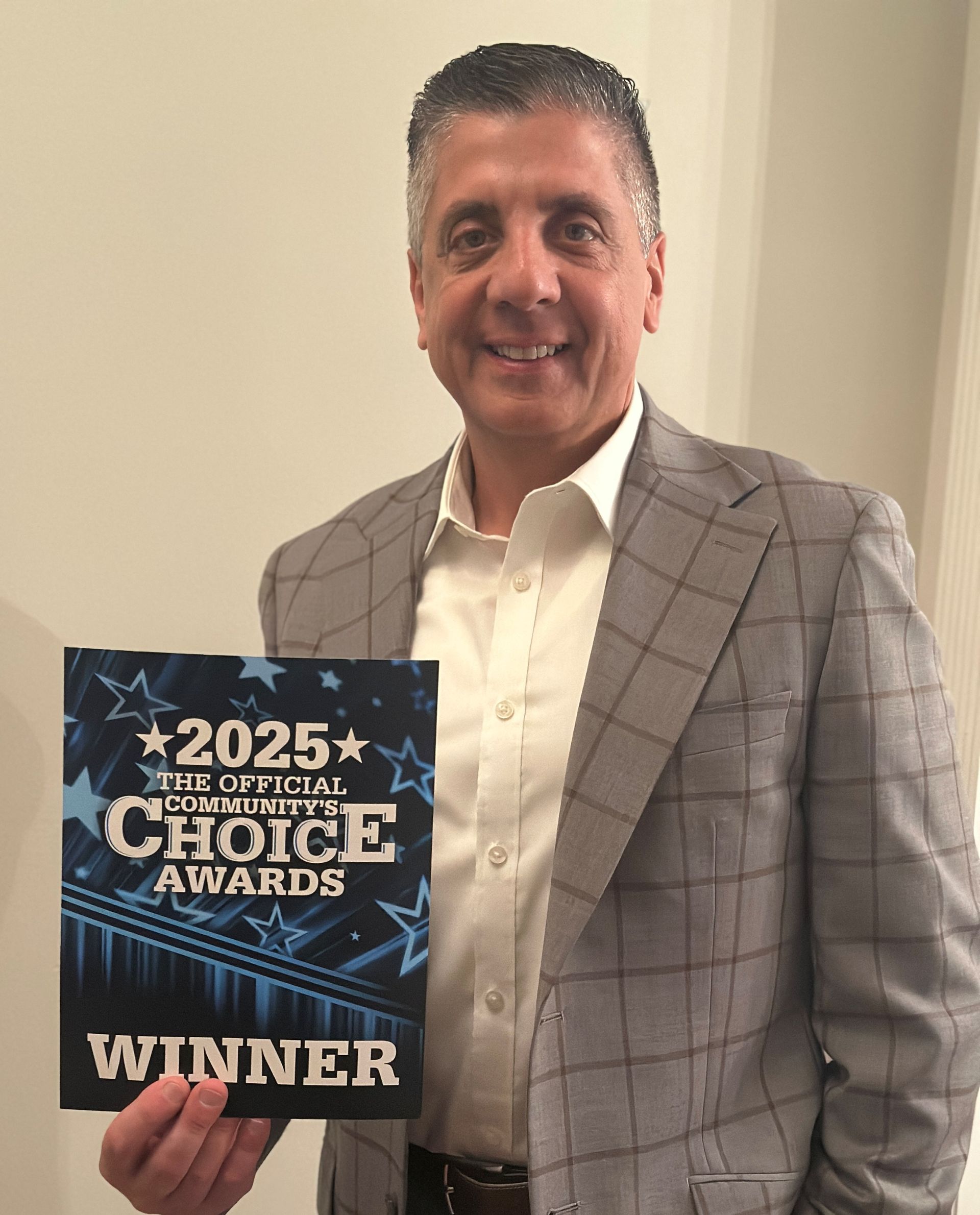 Man in gray blazer holding 