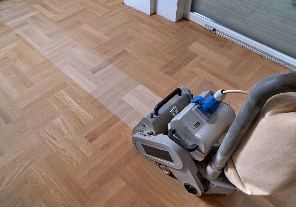 A Machine Is Being Used to Sand a Wooden Floor — Haydyn's Cleaning In Craignish, QLD