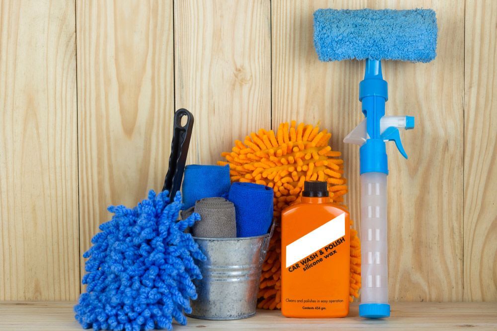 A Bunch of Cleaning Supplies Are on A Wooden Table — Haydyn's Cleaning In Point Vernon, QLD
