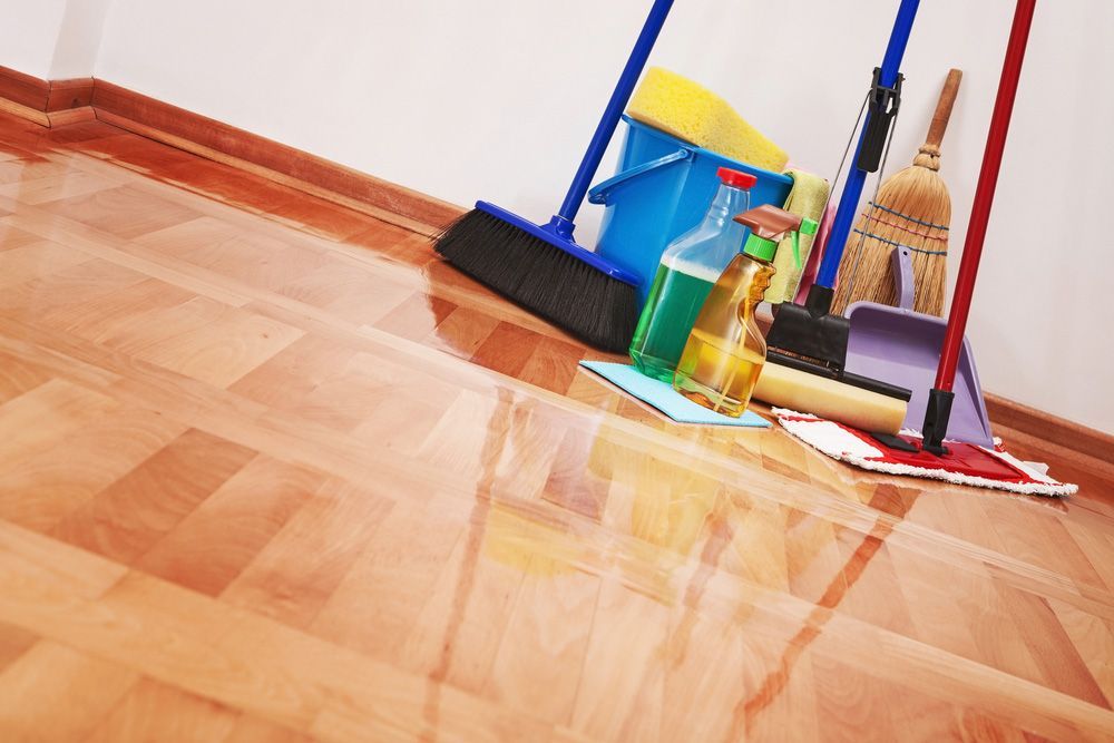 A Wooden Floor with Cleaning Supplies on It — Haydyn's Cleaning In Eli Waters, QLD