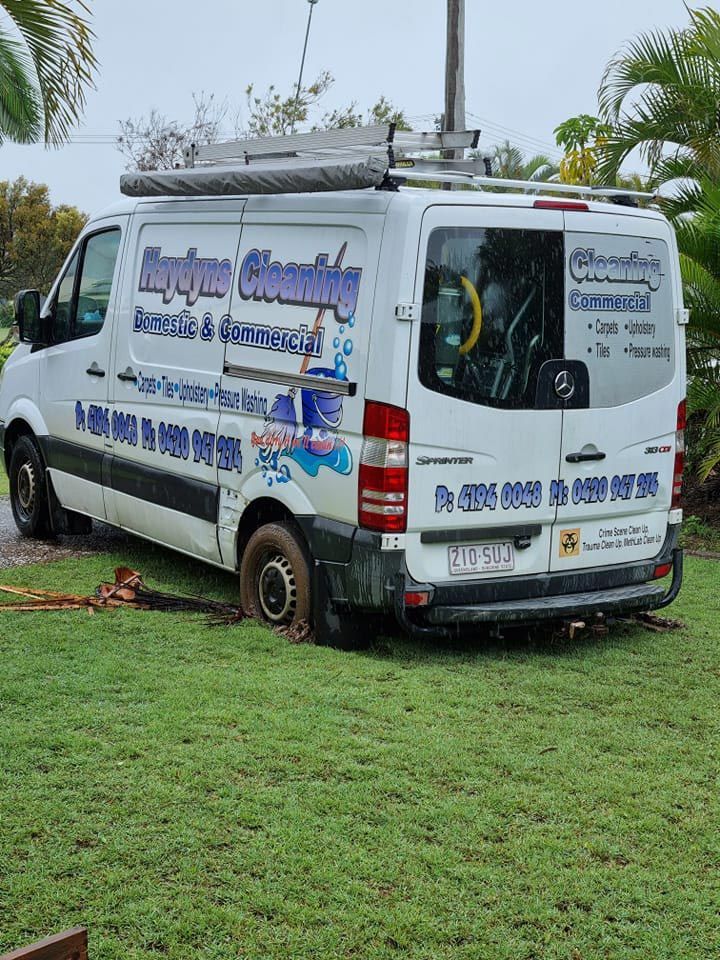  White Van is Parked in a Grassy Field — Haydyn's Cleaning In Urraween, QLD