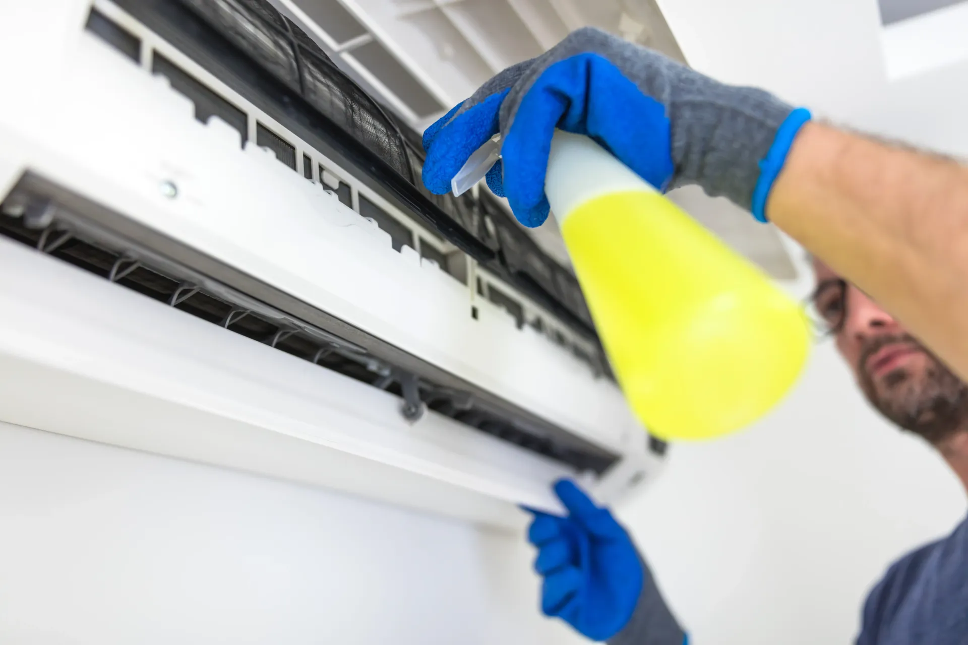 Technician Cleaning a Wall-Mounted Air Conditioner — Haydyn's Cleaning In Urraween, QLD