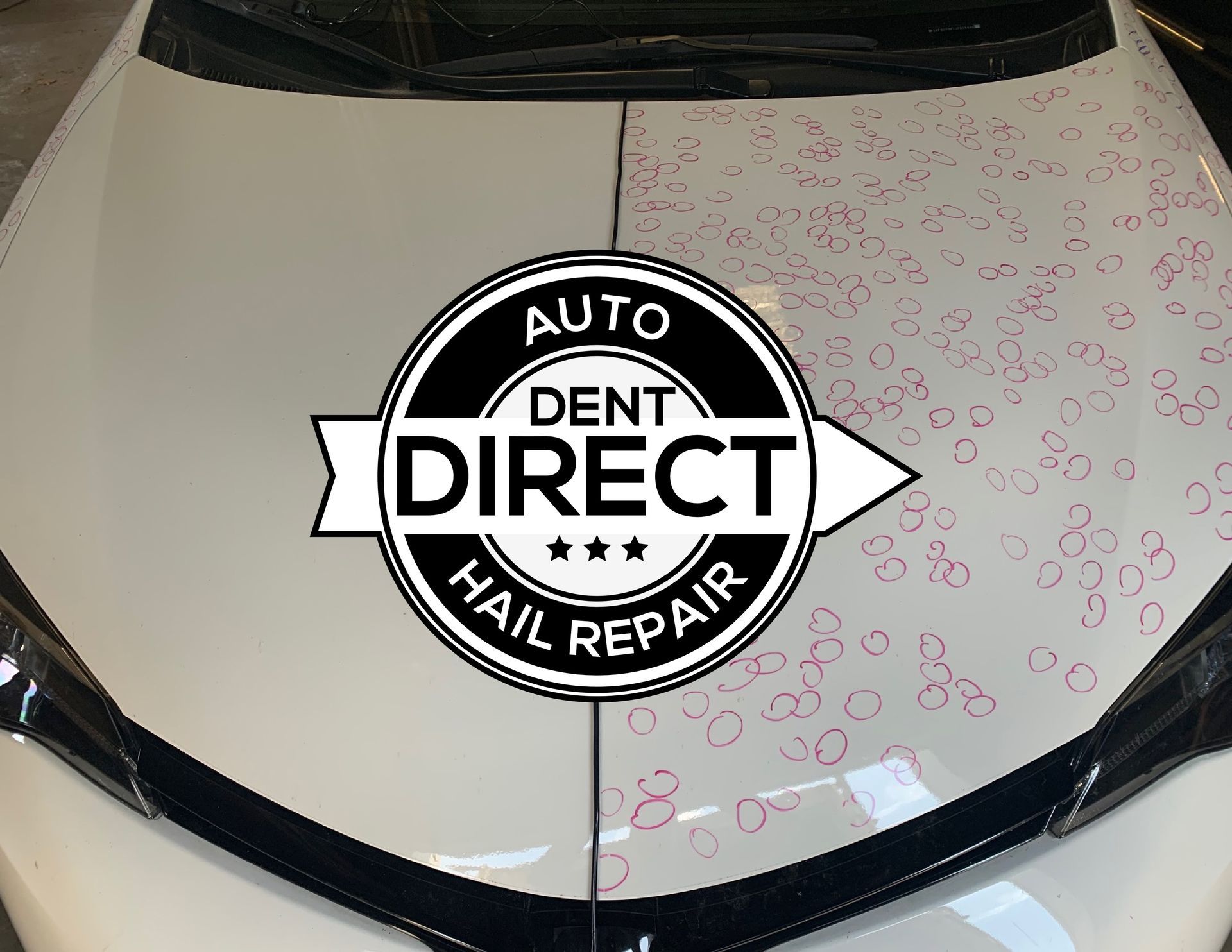 A white car with a dent direct hail repair logo on it
