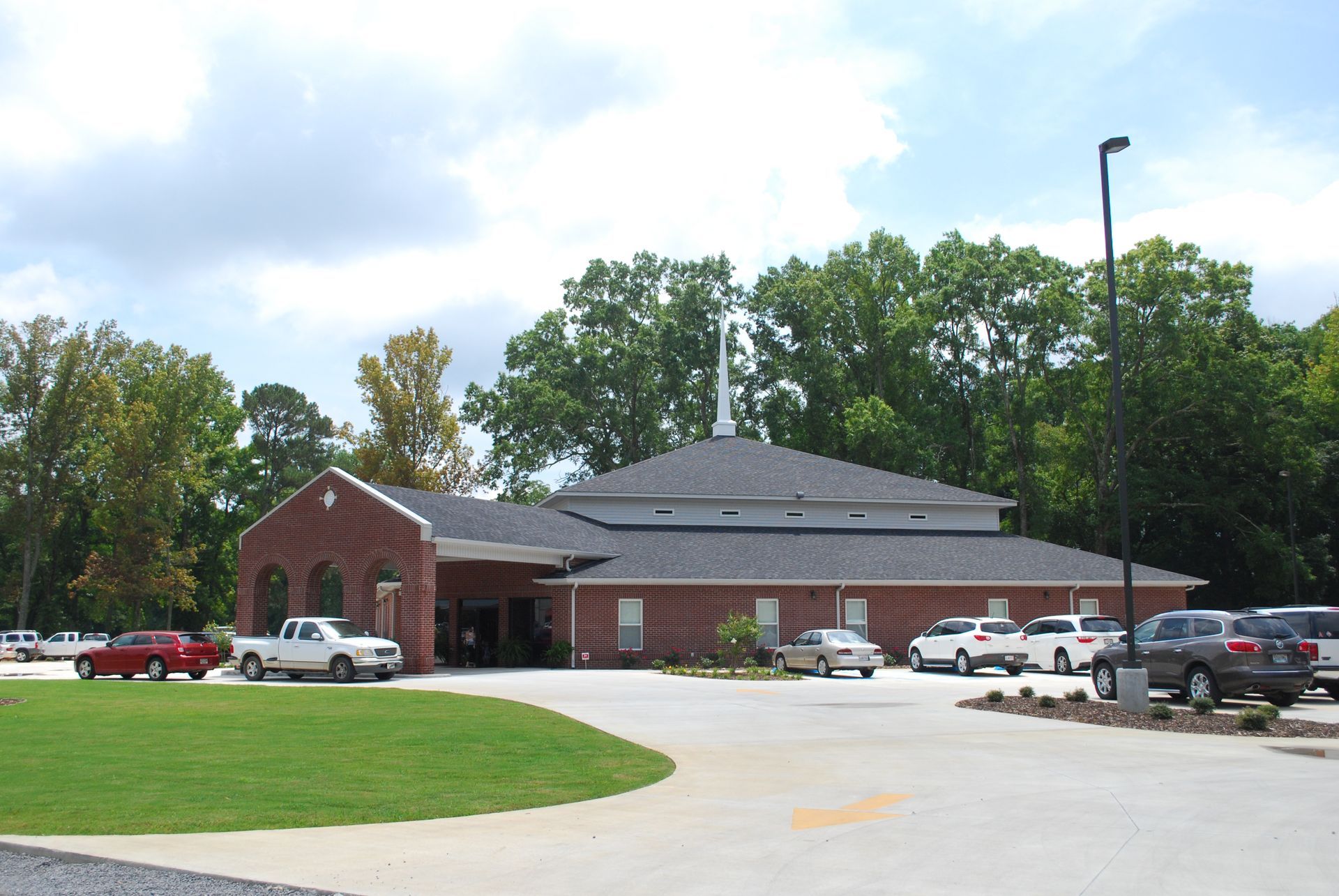 A brick building with cars parked in front of it