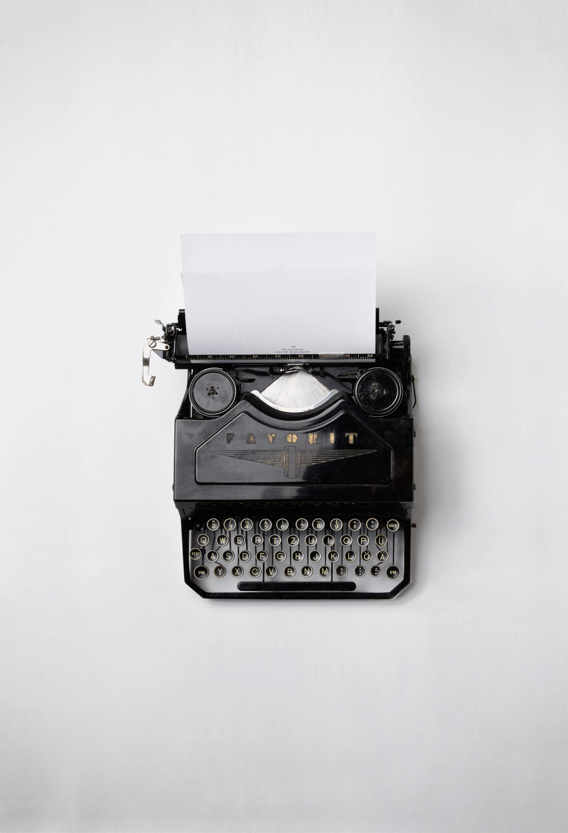 An old typewriter with a piece of paper coming out of it.