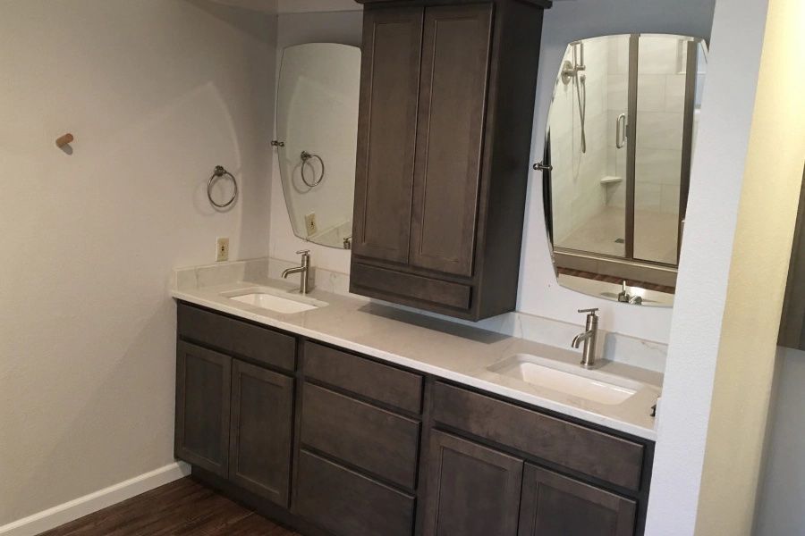 A bathroom with two sinks and two mirrors.