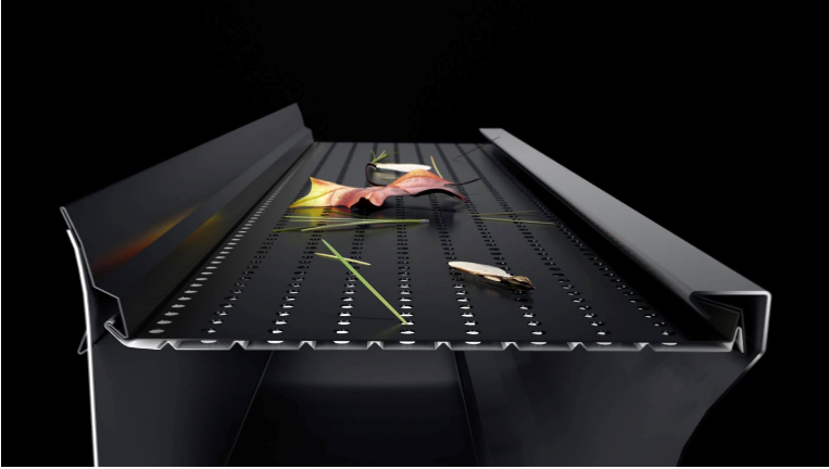 Falling debris on a black conveyor belt with raised side rails