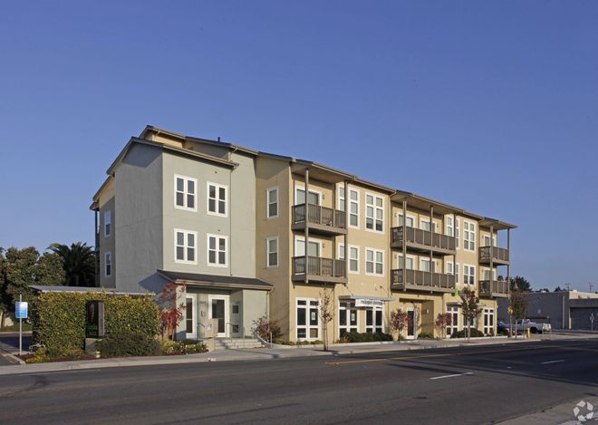 A large apartment building with a lot of windows and balconies