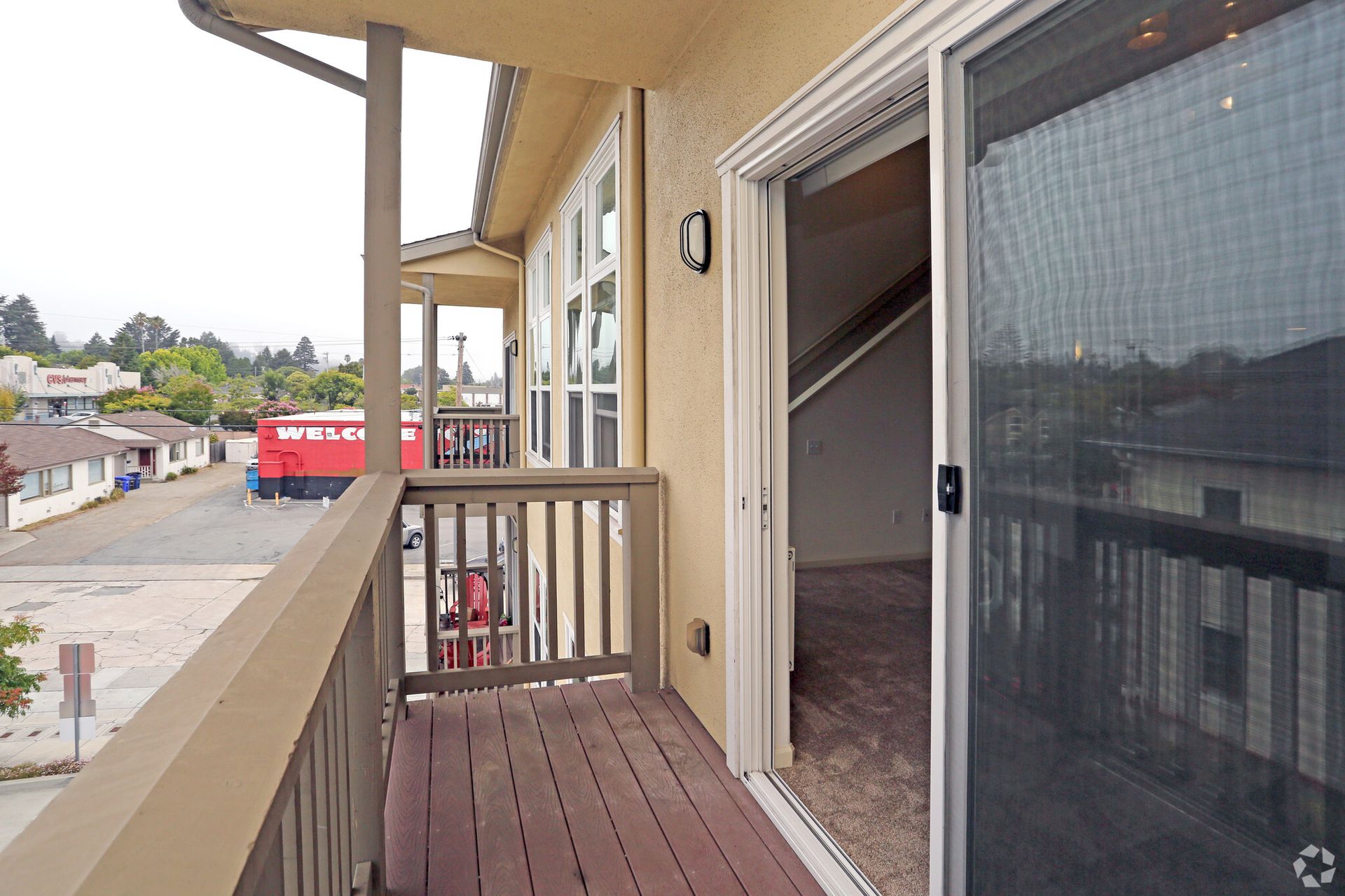 A balcony with a red truck in the background