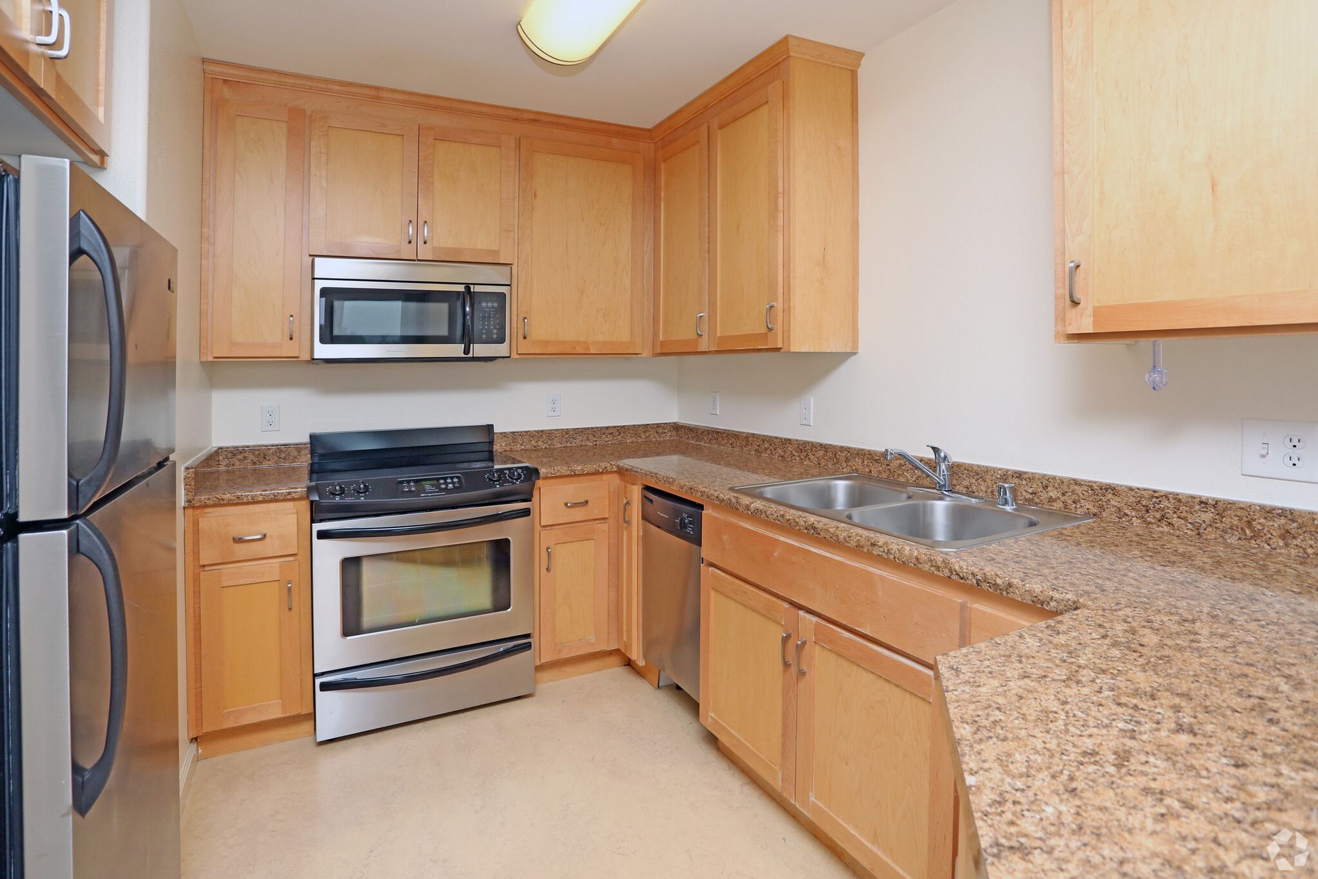A kitchen with stainless steel appliances and granite counter tops