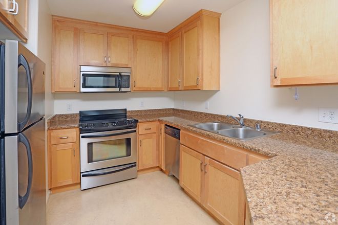 A kitchen with stainless steel appliances and granite counter tops
