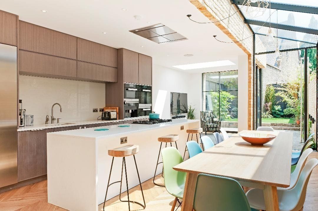 A kitchen with a large island and a table and chairs