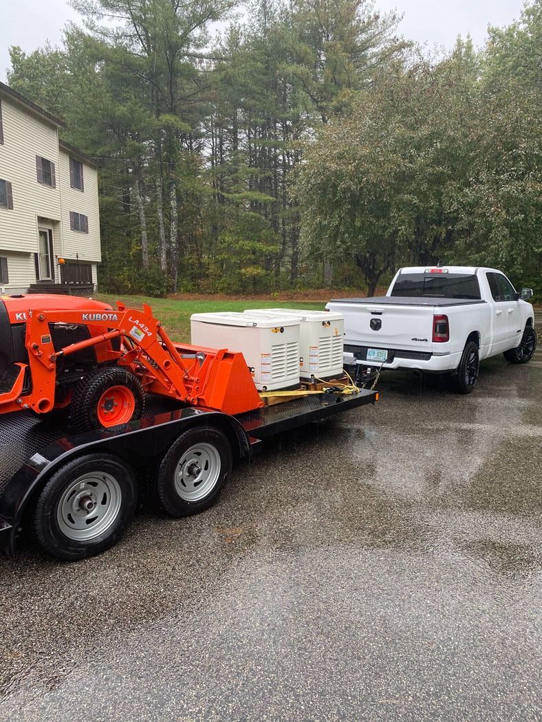 White pickup towing a trailer with an orange skid steer on a gravel driveway in the rain