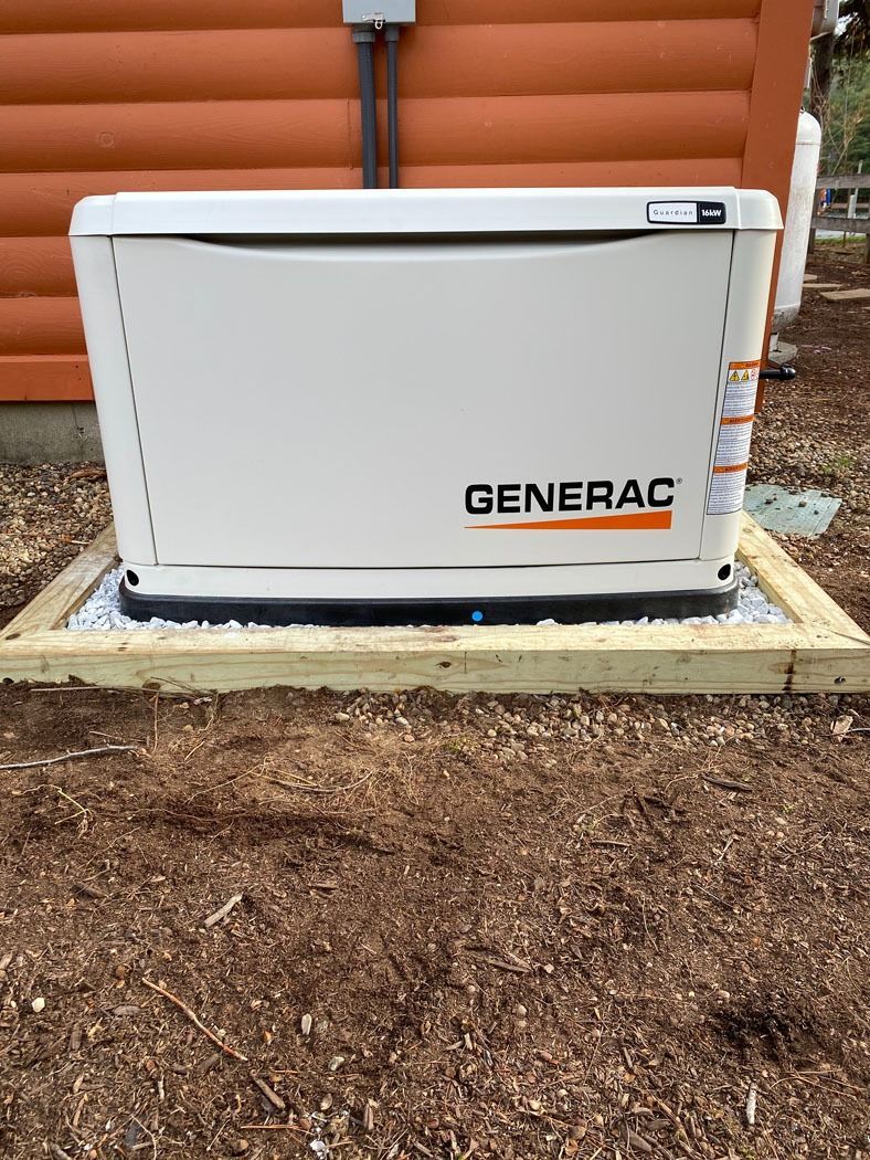 White Generac generator unit beside a house on a concrete pad, with orange siding in the background.