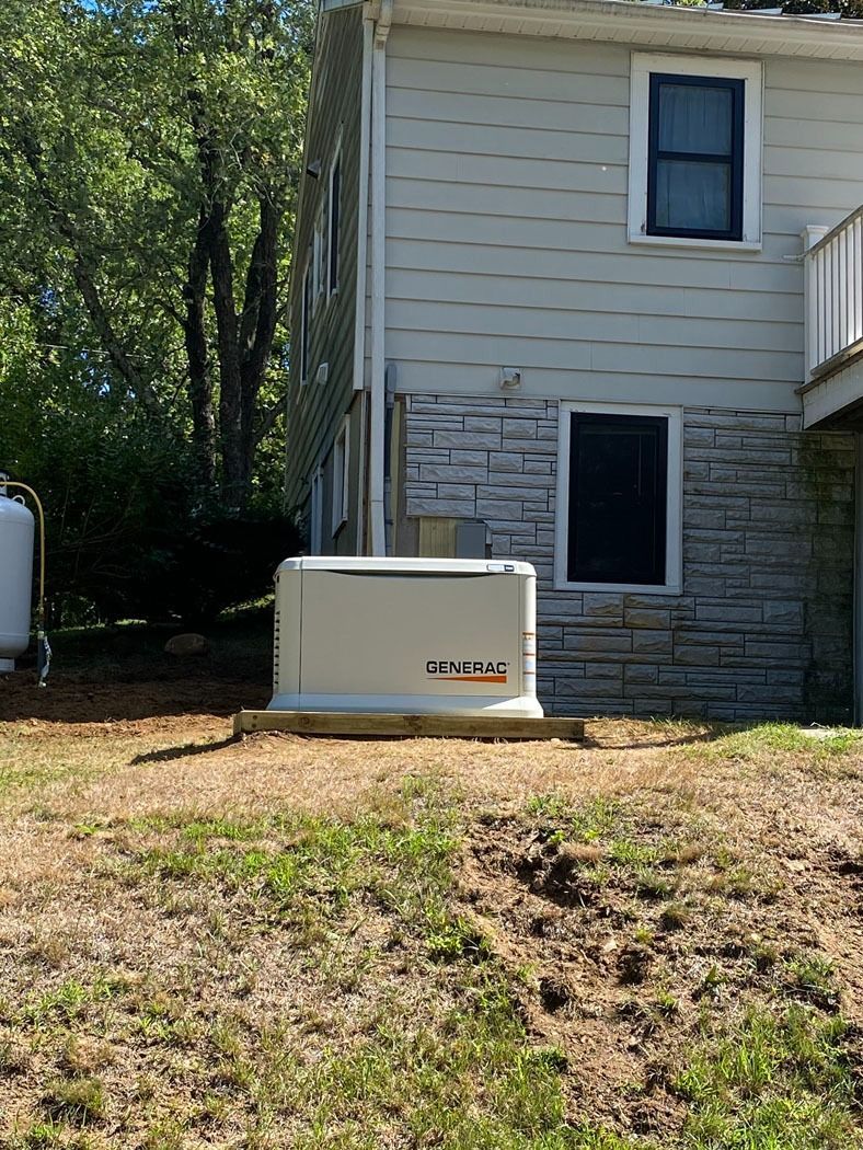 Residential home exterior with a beige generator unit beside the house on a grassy yard
