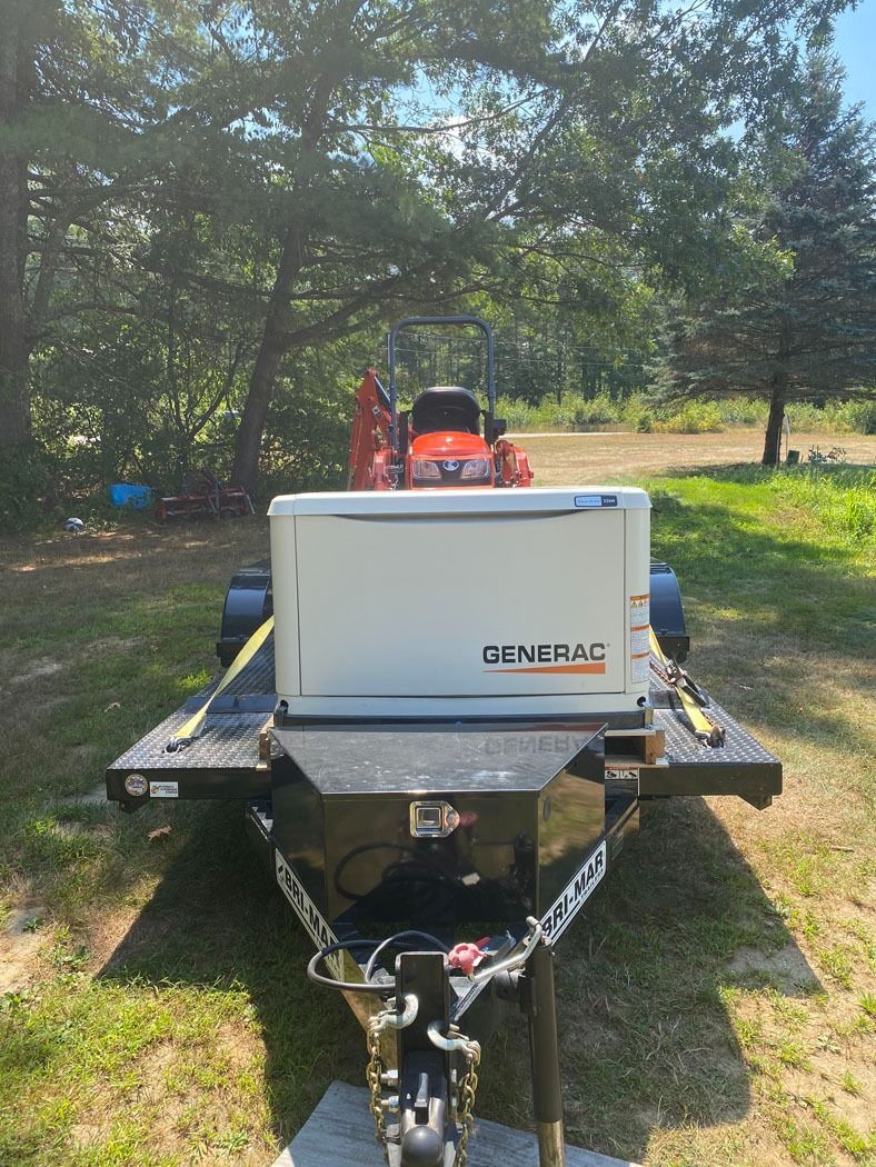 White utility trailer with a black hitch and orange equipment parked on grass under trees