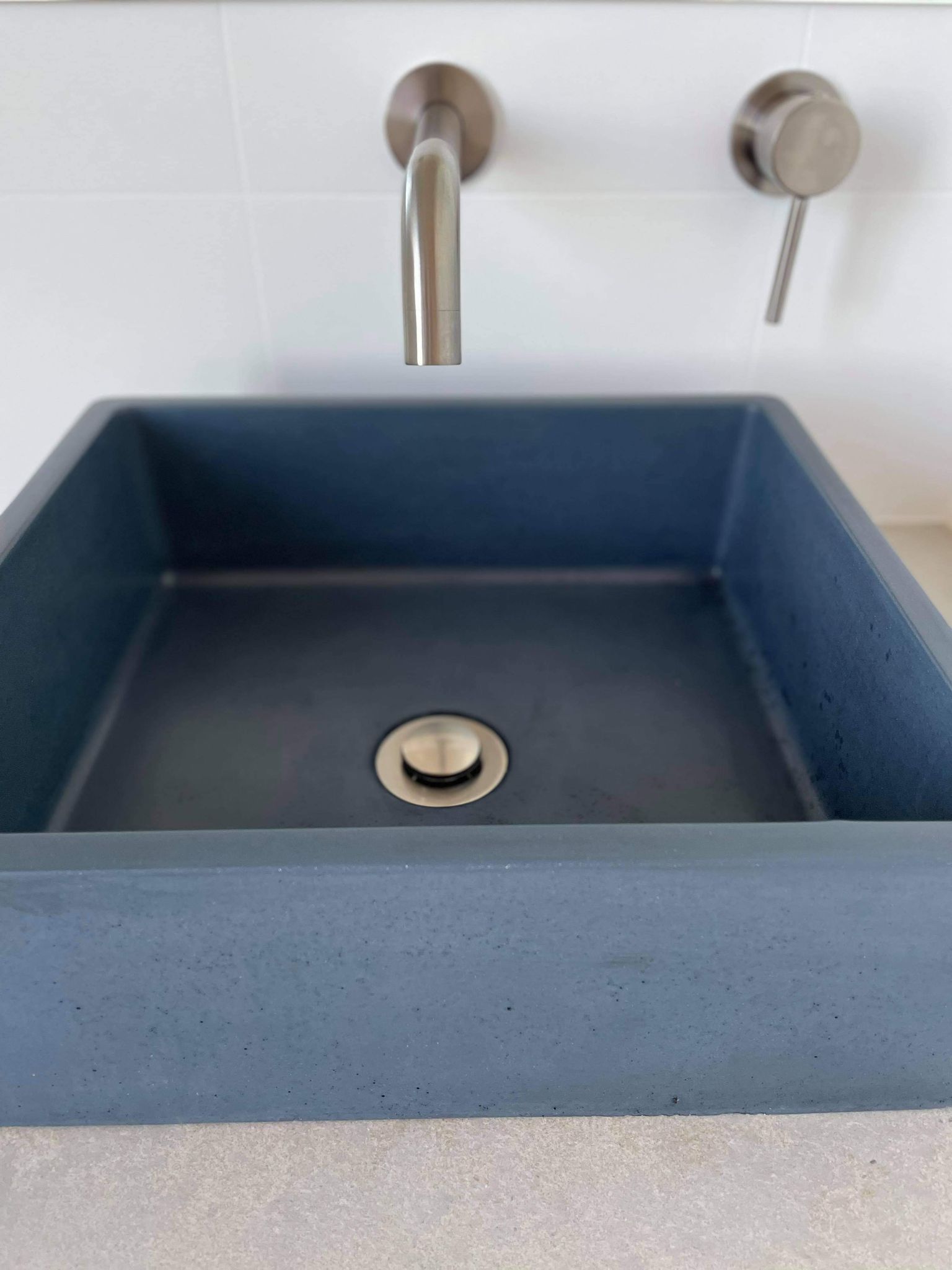 A bathroom sink with a drain and a faucet.