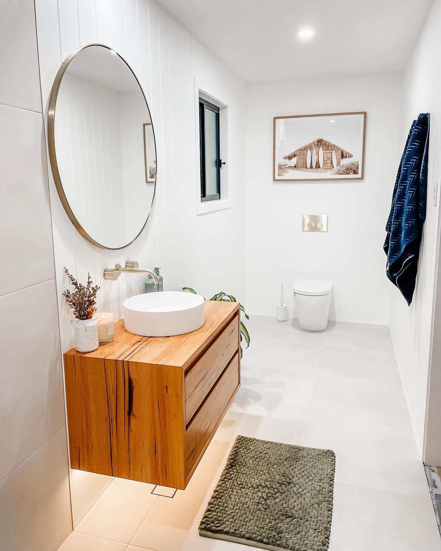 A bathroom with a sink , mirror and toilet