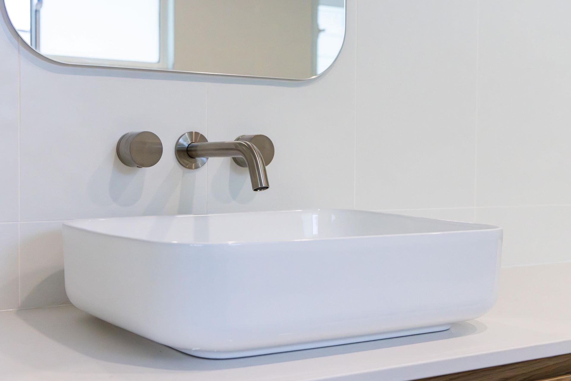 A bathroom sink with a mirror above it and a faucet.