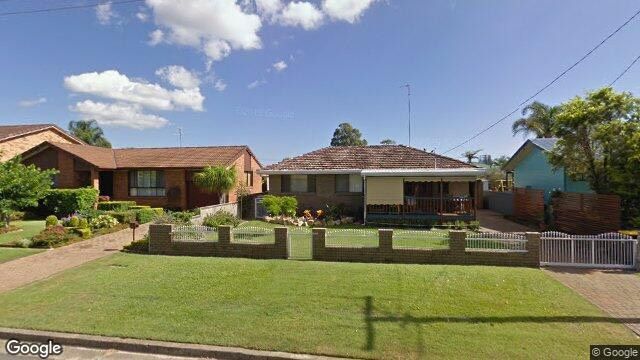 A couple of houses are sitting next to each other on a lush green lawn.
