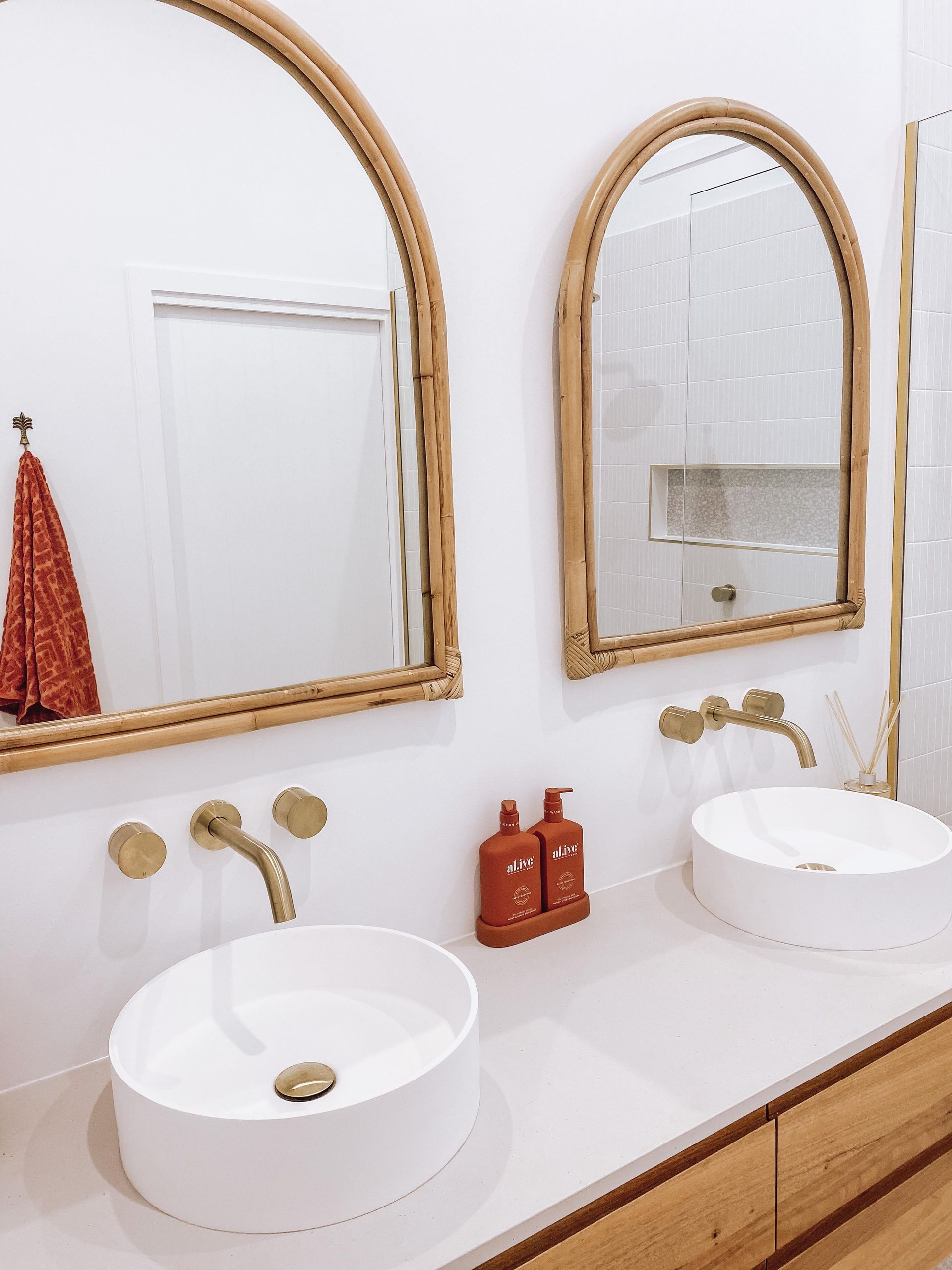 A bathroom with two sinks and two mirrors.