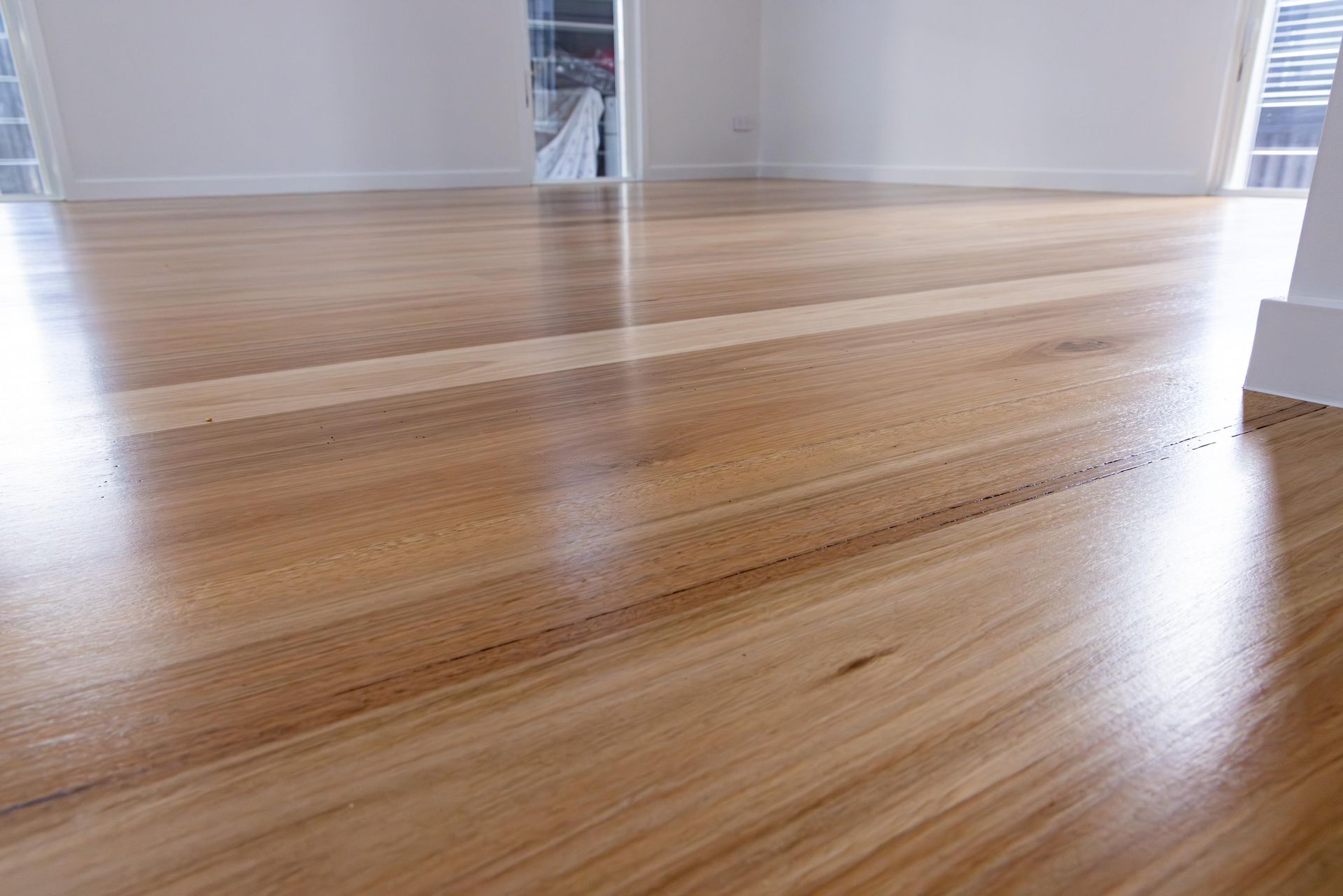 A close up of a wooden floor in an empty room.