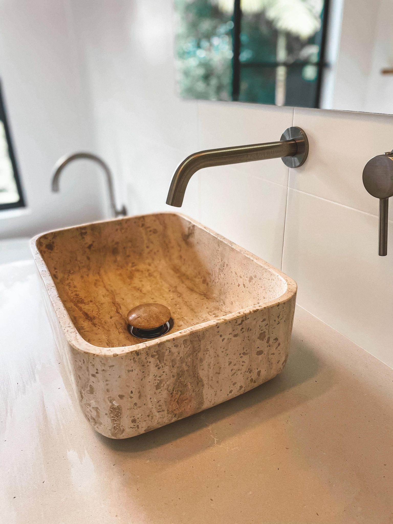 A bathroom sink with a faucet and a mirror.