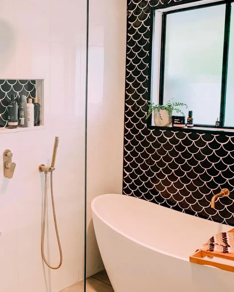a bathroom with a bathtub , shower , and mirror .
