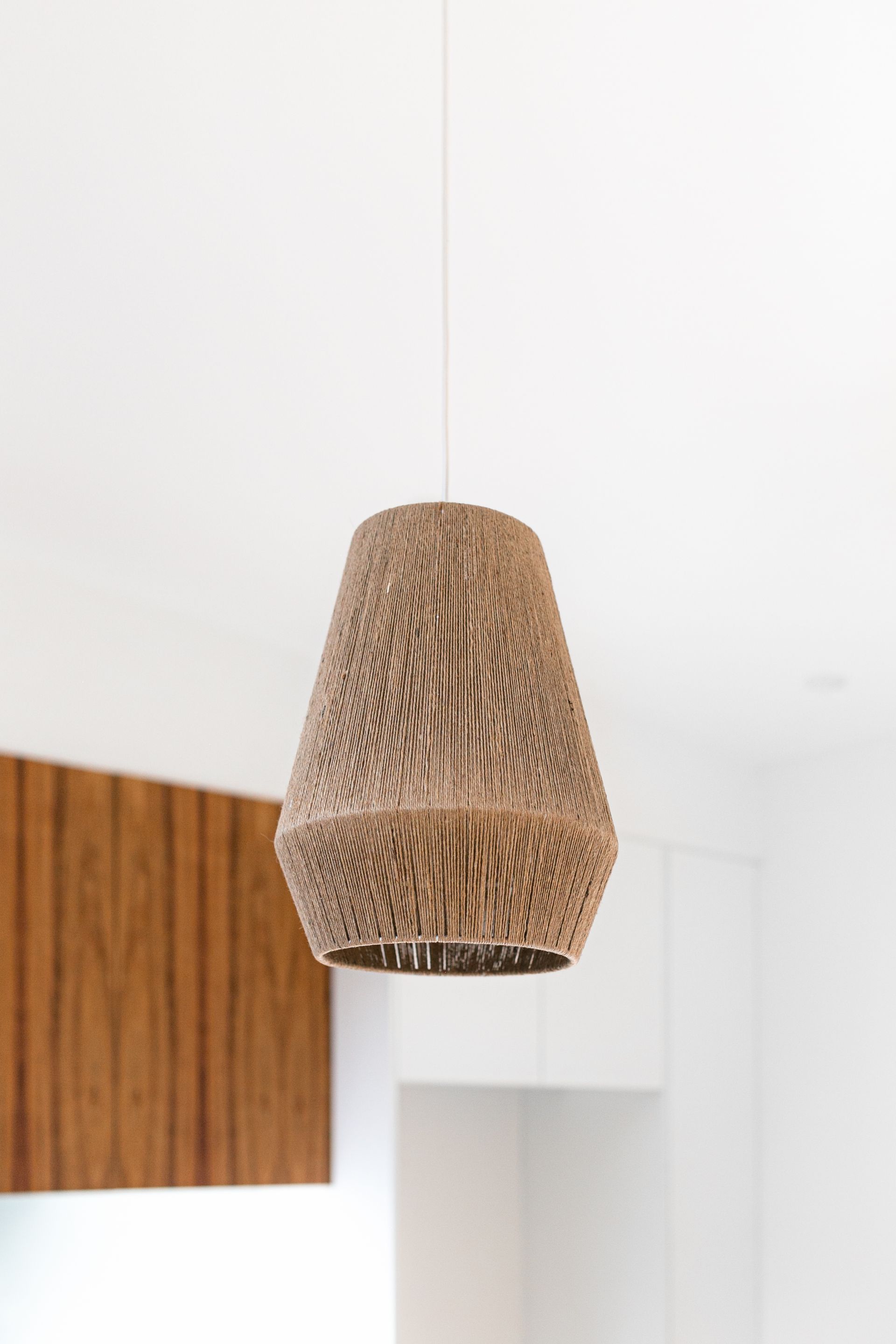 A pendant light is hanging from the ceiling in a kitchen.
